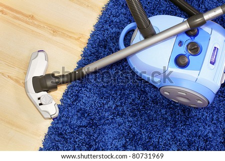 Vacuum cleaner stand  on blue carpet