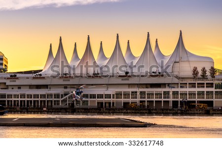 VANCOUVER, BC, CANADA - SEPT 12, 2015: A BC Air Ambulance helicopter landing on the pad in front of Canada Place in Vancouver harbor.