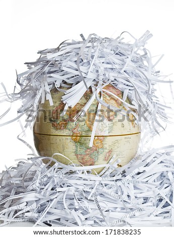 Earth globe covered with shredded paper