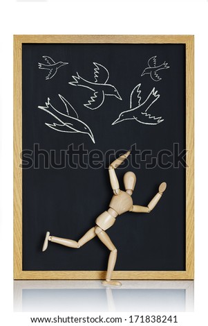 The birds. Manikin, anatomical model, placed on a chalkboard with birds drawn on it.