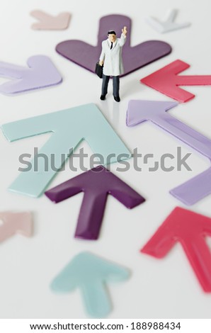 Business Figurine with arm raised with arrows