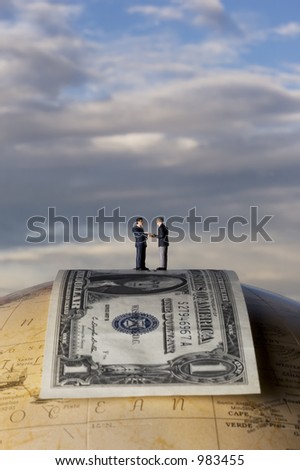 business figures standing on dollar bill, on a globe