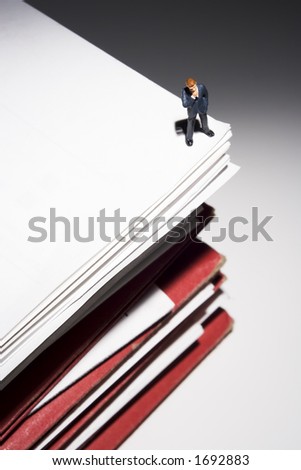 Business figures and stacks of papers and folders