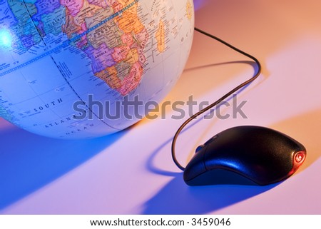 Computer mouse connected to an earth globe.