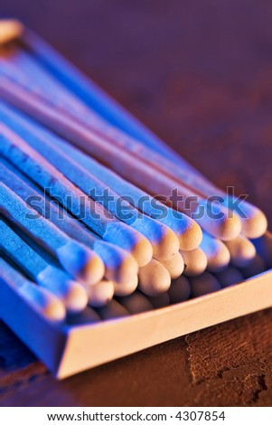 Macro photograph of matches with directional blue and orange lighting
