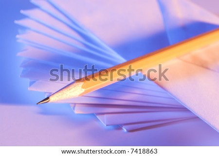 Pencil placed on a spiral pattern of envelopes