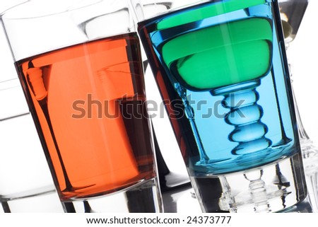 Colorful drinks on a reflective tabletop.
