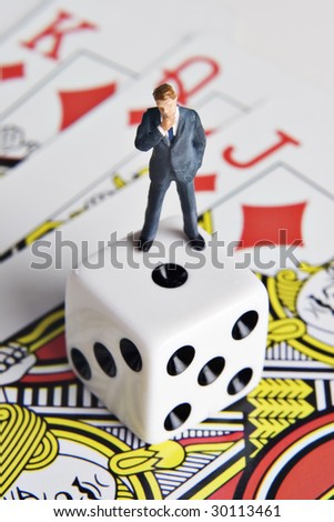 Business figurine, dice, and playing cards