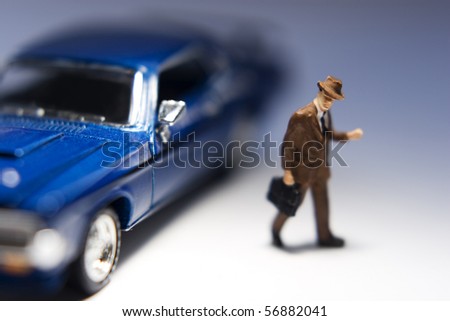 Businessman figurine with briefcase leaving a blue car