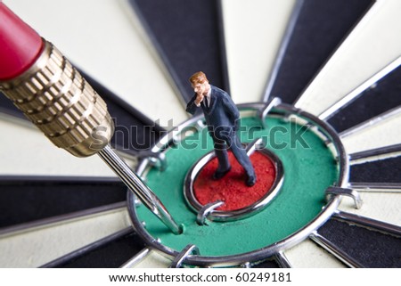 Businessman figurines placed on a dartboard