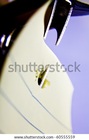Staple remover tearing at a piece of paper