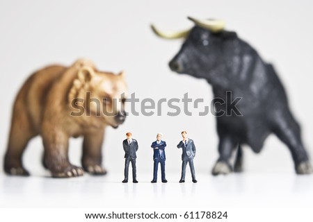 Business figurines placed with bull and bear figurines.
