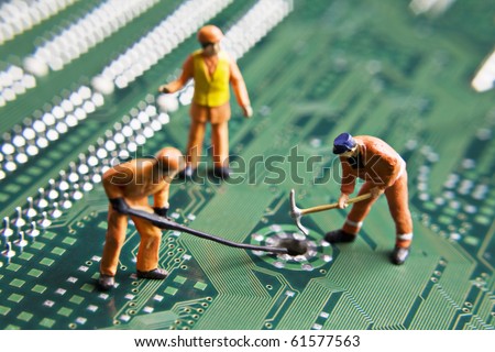 Worker figurines placed on a computer circuit board
