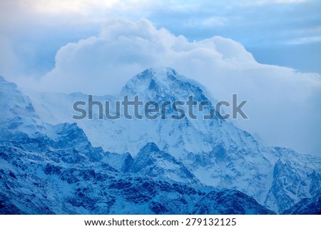 beautifull cloudy sunrise in the mountains with snow ridge. Trek around Annapurna mount. Himalaya, Nepal.