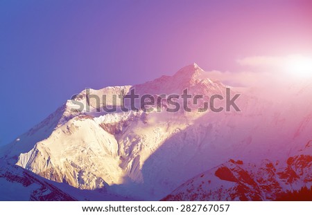 beautifull cloudy sunrise in the mountains with snow ridge