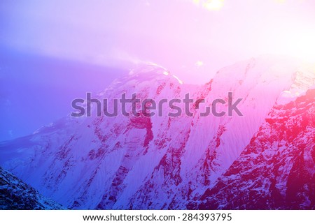 beautifull cloudy sunrise in the mountains with snow ridge