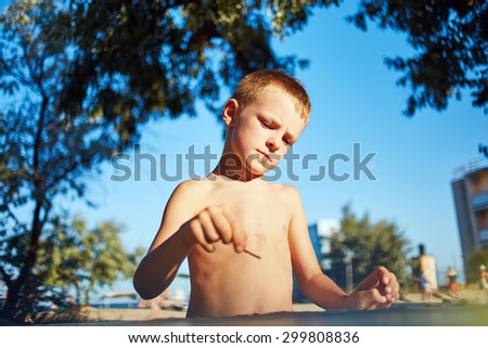 little boy with sketch pen drawing in outdoor