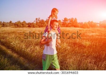 family in the field at the  sunset