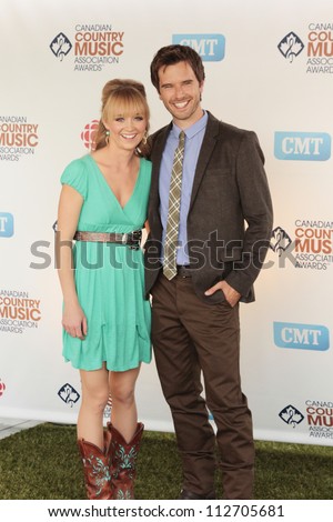 SASKATOON, CANADA - SEPT 9: Heartland\'s Amber Marshall and Graham Wardle arriving to the 2012 Canadian Country Music Association Awards at Credit Union Centre on September 9, 2012 in Saskatoon, Canada