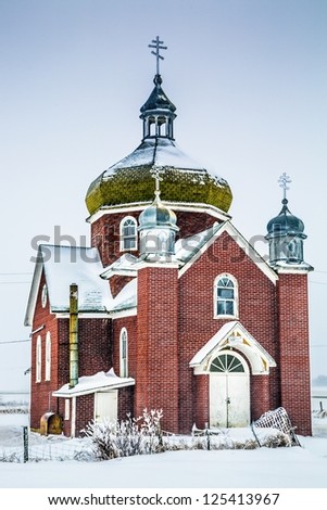 An old red brick church in a winter storm