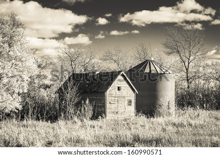 Grain bins on an old praire farm. Processed with an infrared monochrome filter.
