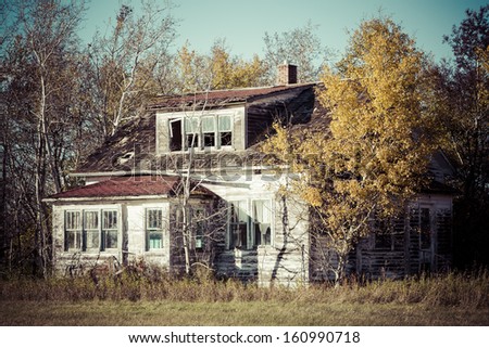 An old weather and rustic abandoned farm house.