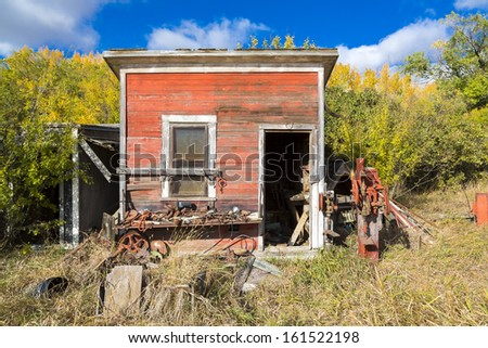 An old shed on a farm full of rusty parts