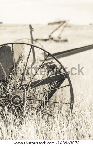 Old steel farm machinery abandoned in the field