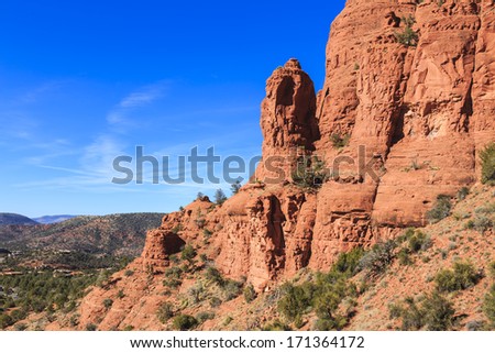 The red rocks found in the Sedona, Arizona area. The red sandstone formations appear to glow in brilliant orange and red when illuminated by the rising or setting sun.