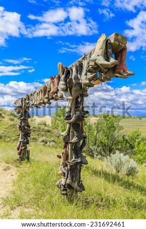 The hanging cowboy boots at the Great Sand Hills near Sceptre, Saskatchewan.  These old hanging boots are a memorial to John Booth who was a local rancher and lived in the area his entire life.