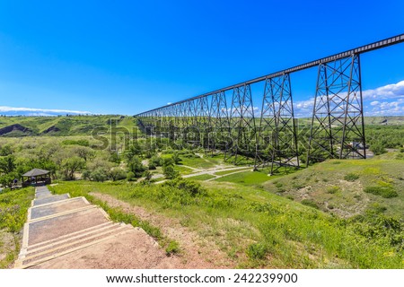 Path by the High Level Bridge in Lethbridge, Alberta, Canada. The bridge is the longest and highest trestle bridge in the world soaring above the Oldman River.