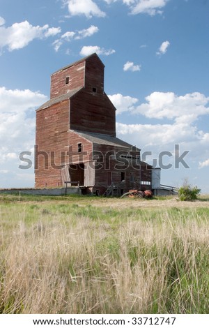 An old abandoned grain elevator on the Canadian prairies.  Trademarked logos have been removed.