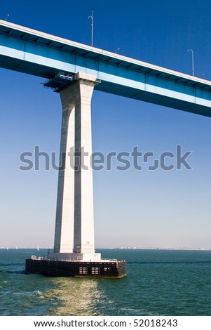 Tall pillar on the San Diego - Coronado Bridge over the blue water.