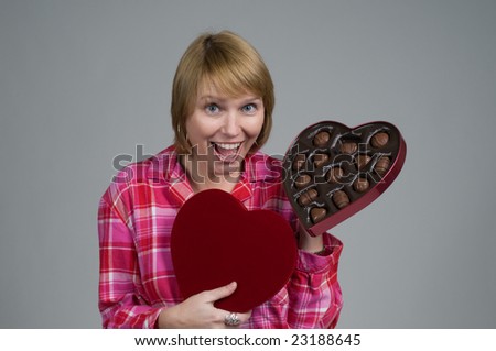 stock photo : An attractive woman in pajamas receiving a gift of valentines 