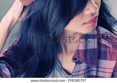 Close up portrait in vintage style, half face of dark haired hipster girl looking away