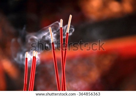 Burning red incense sticks in Chinese temple