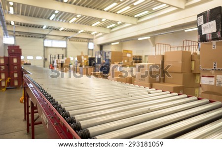 Package conveyor belt for distributing packages for delivery is seen in foreground in the DHL warehouse in Sofia, Bulgaria, October 7, 2014.