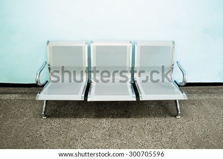 Metal seats in an empty bright hospital hall.