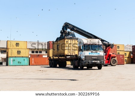 A mobile crane is loading cargo truck at container terminal at Varna port, Varna, Bulgaria, May 16, 2014.