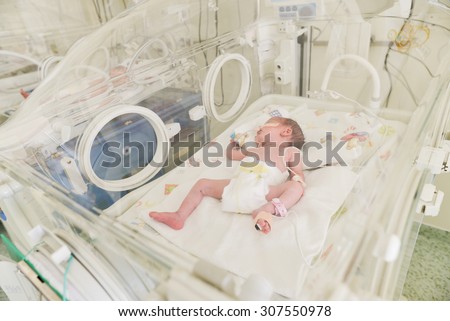 Close-up of a newborn innocent baby sleeping in an incubator in the Obstetrics and Gynecology Hospital \