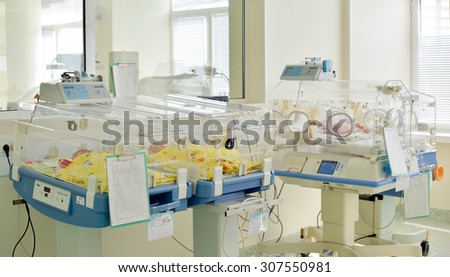 Newborn innocent babys are sleeping in incubators in the Obstetrics and Gynecology Hospital \