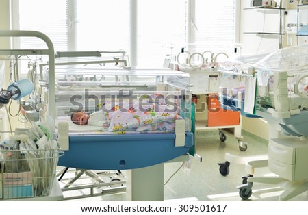 Close-up of a newborn innocent baby sleeping in an incubator in the Obstetrics and Gynecology Hospital \