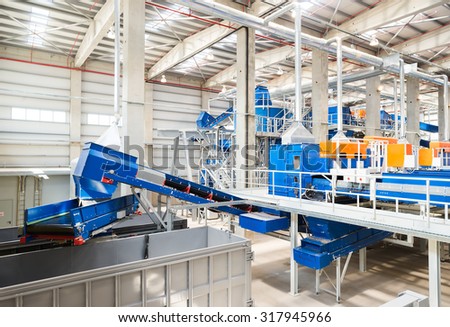 Sofia, Bulgaria - Pipes and conveyor belt machinery for processing recycled organic waste in a recycling waste to energy and composting factory.