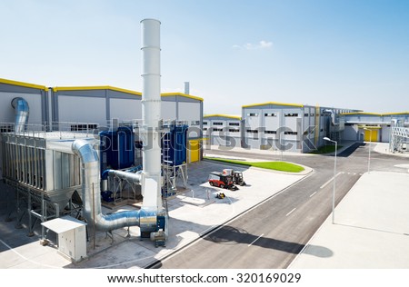 Sofia, Bulgaria, September 14, 2015 - General view of a recycling waste to energy and composting factory with bio gas chimney pipeline installation and silo for recycled waste material from outside.