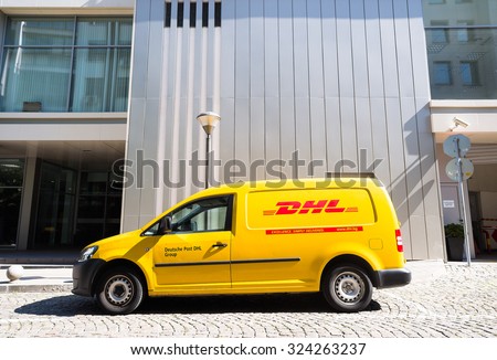 DHL Volkswagen delivery car during service in front of office building in bright sunny day in Sofia, Bulgaria, October 5, 2015.