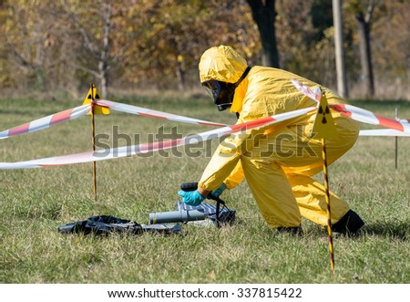 Radiation scientist dosimetrist in protective clothing and gas mask with geiger counter checks the radiation level and spectra in hazardous zone, Sofia, Bulgaria, November 6, 2015.