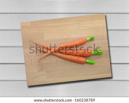 Carrots isolated on a wooden chopping board