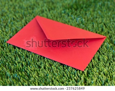 A close up shot of an envelope on artificial grass