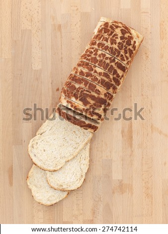 A loaf of bread on a wooden bench top