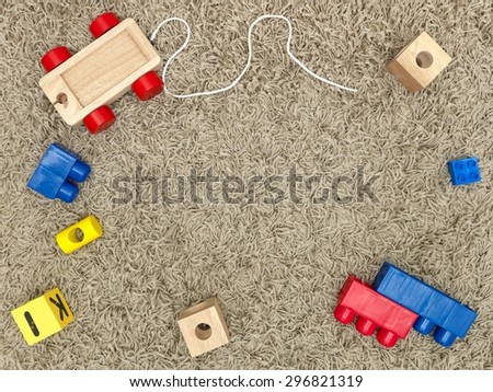 A close up shot of toys scattered over a wooden floor
